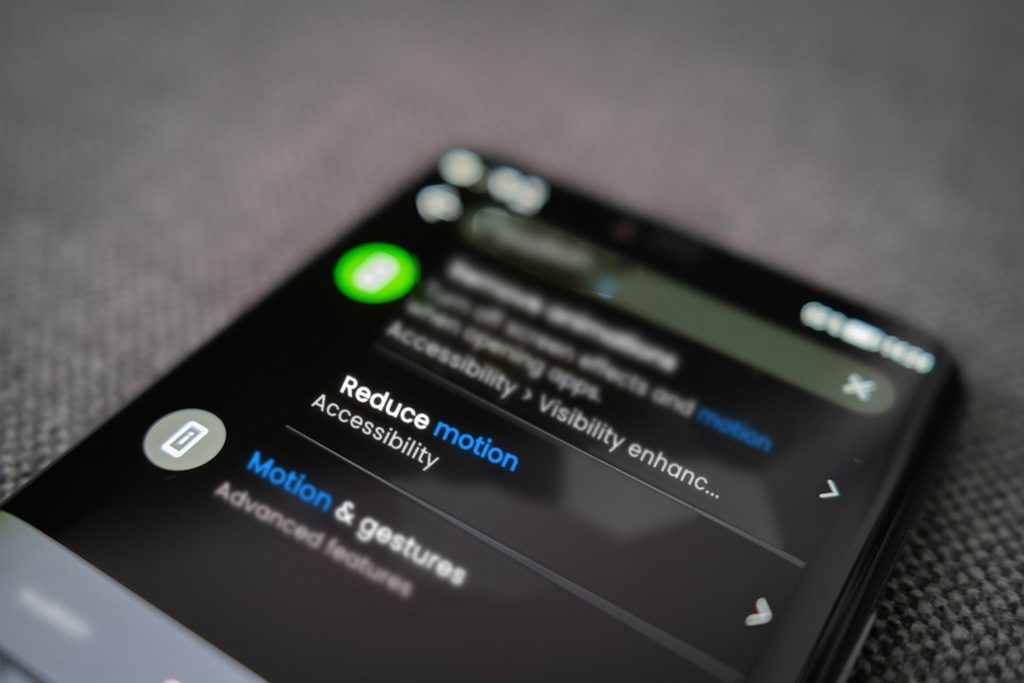 Close-up of a smartphone settings screen showing search results for motion, with the Reduce motion setting in focus.