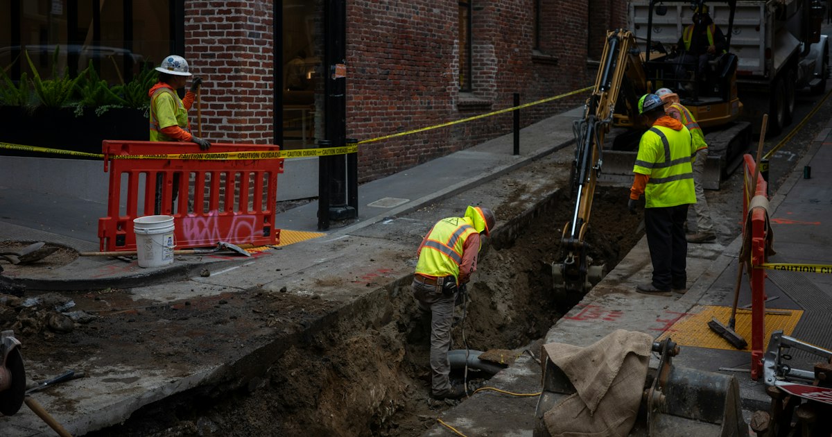 Crew excavating a trench on a city street